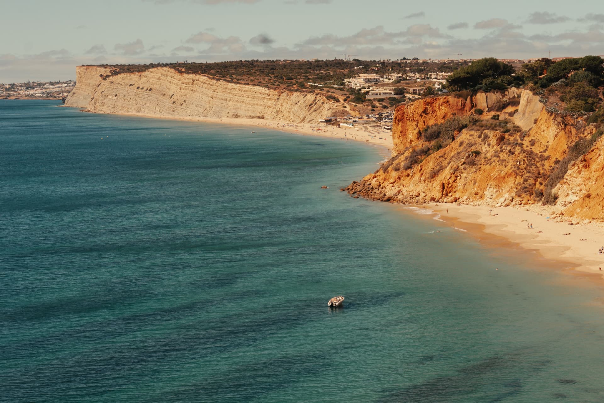 Praia de Porto de Mós beneath golden cliffs